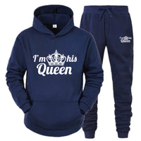 a blue sweat suit with a crown on it