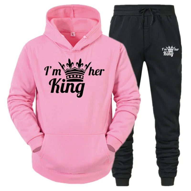 a pink hoodie and black pants with a crown on it