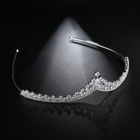 a tiara on a black surface with a black background