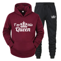 a red and black sweatshirt and pants with a crown on it