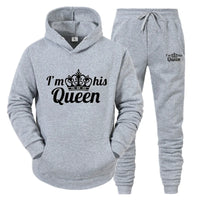 a grey sweat suit with a crown on it
