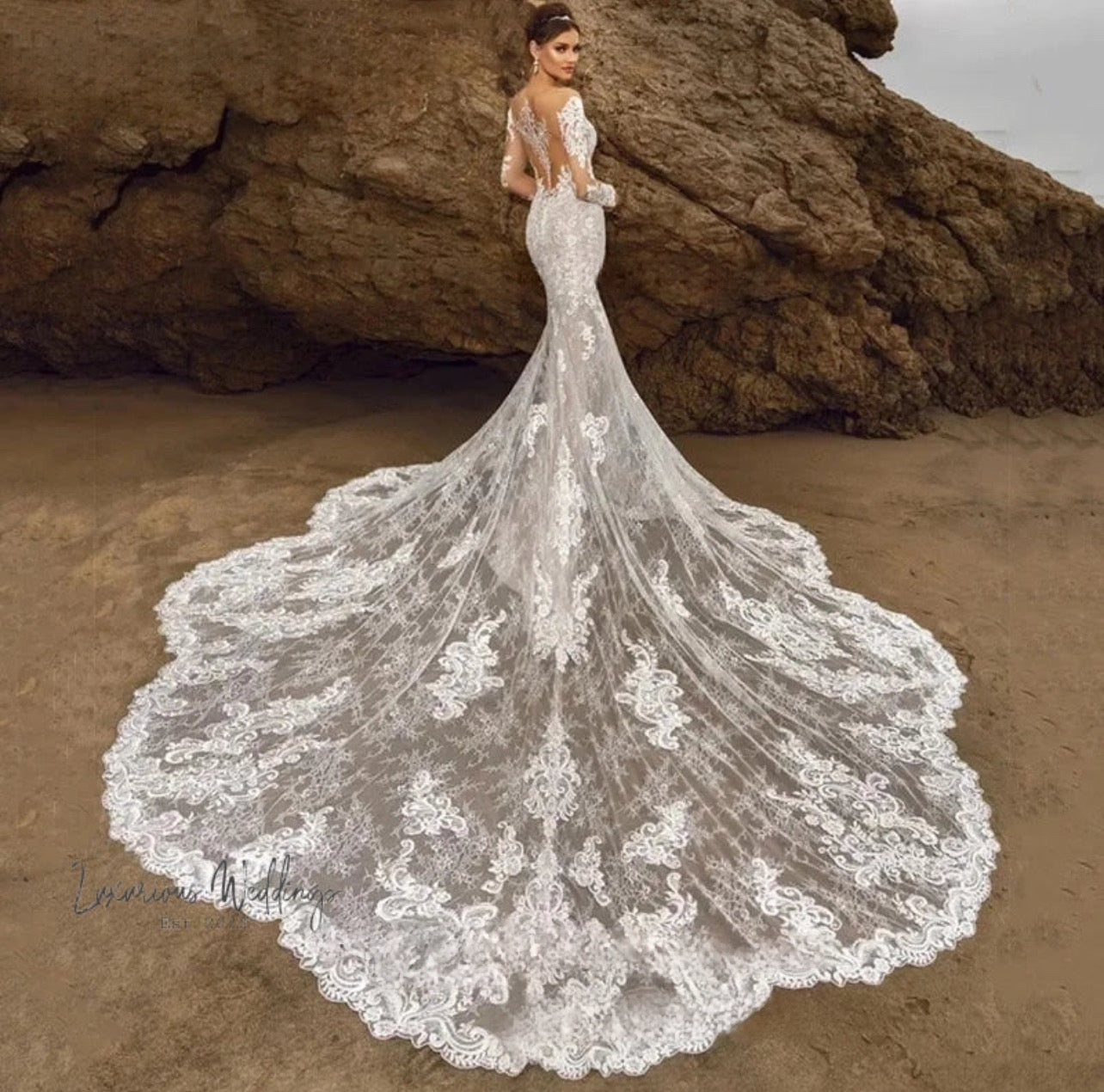 a woman in a wedding dress standing on a beach