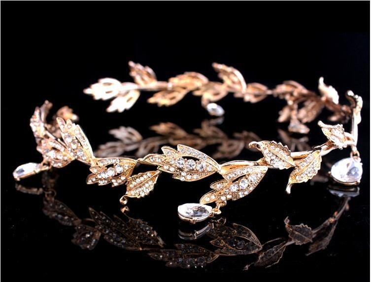 a close up of a gold bracelet on a black surface