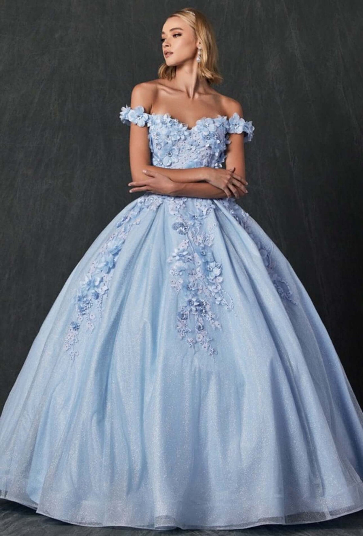 a woman in a blue ball gown posing for a picture