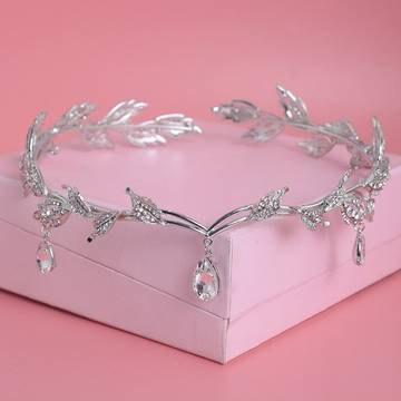 a tiara on a pink box on a pink background
