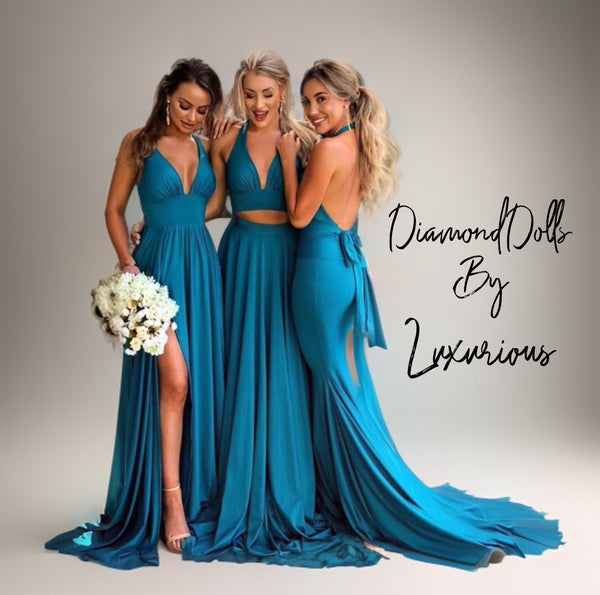 three beautiful women in blue dresses posing for a picture