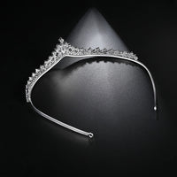 a tiara on a black background with a spotlight