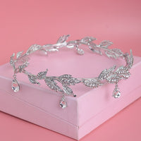 a tiara on a pink box on a pink surface