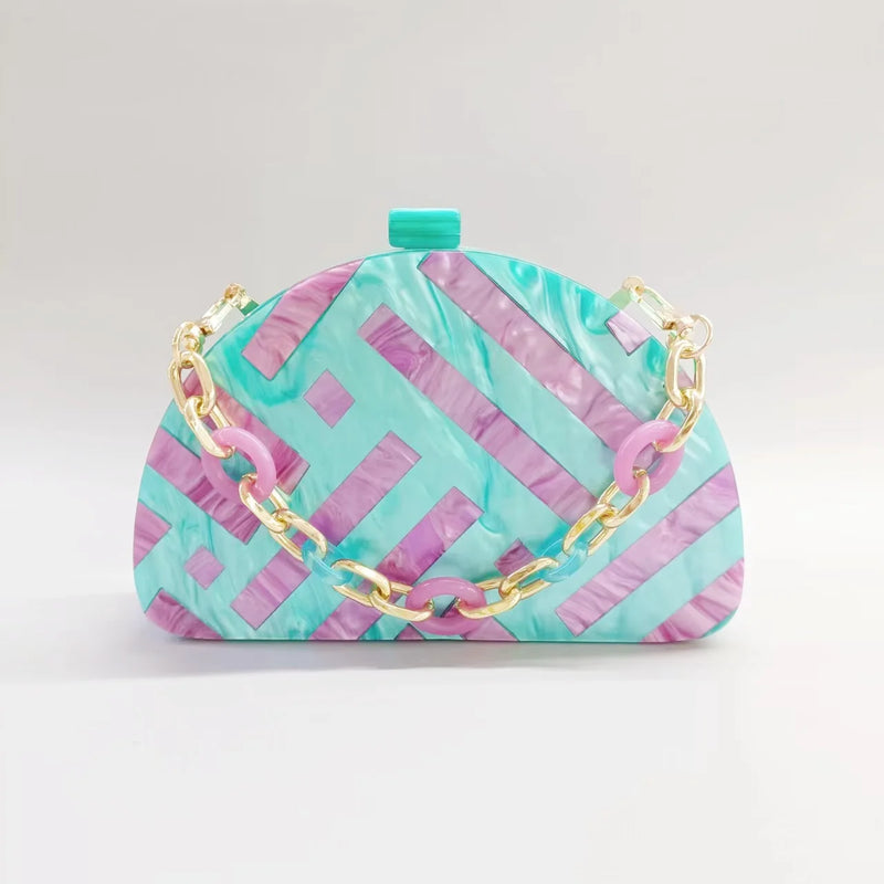 Half room geometric pearl acrylic box clutch in teal and pink, ideal for luxurious weddings.