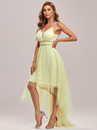 a woman in a yellow dress posing for a picture