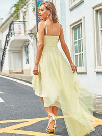 a woman in a yellow dress is walking down the street