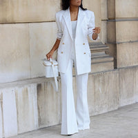 a woman wearing a white suit and hat
