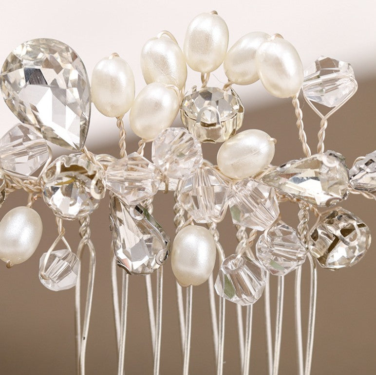a close up of a hair comb with pearls