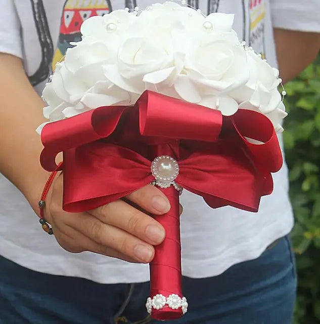 a person holding a red and white bouquet of flowers