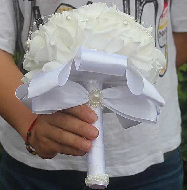 a person holding a bouquet of white flowers