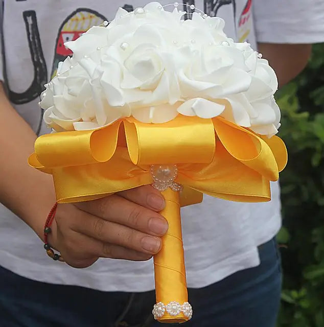 a person holding a bouquet of flowers in their hand