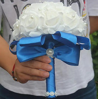 a person holding a bouquet of white roses