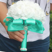 a person holding a bouquet of white flowers