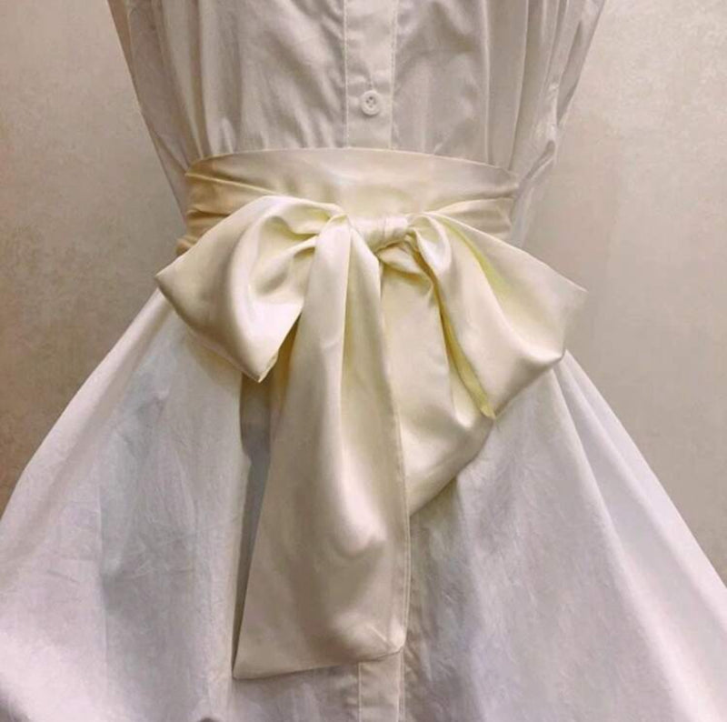 Ivory bridesmaid waist sash tied elegantly around a dress, adding a chic accent to formal attire.