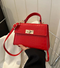 a person holding a red purse in their hand