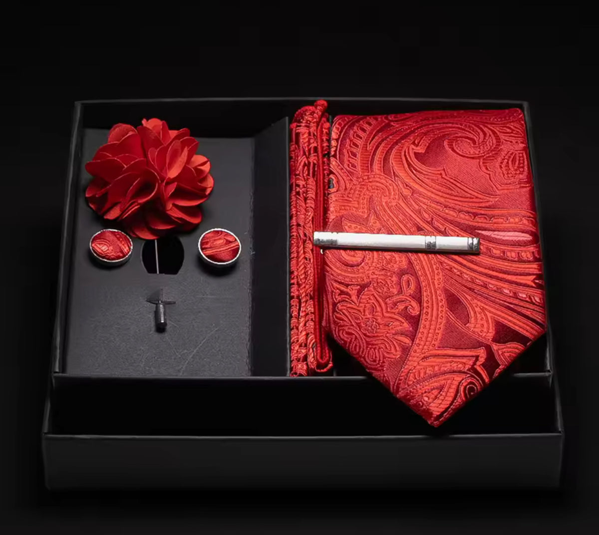 Luxurious red silk tie, cufflinks, pocket square, and flower lapel in elegant gift box.