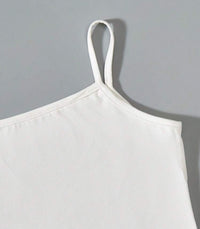 a white apron hanging on a gray wall