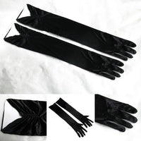 a pair of black gloves sitting on top of a white sheet