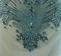 a close up of a dress with beads on it