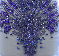 a close up of a dress with beads on it