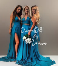 three beautiful women in blue dresses posing for a picture