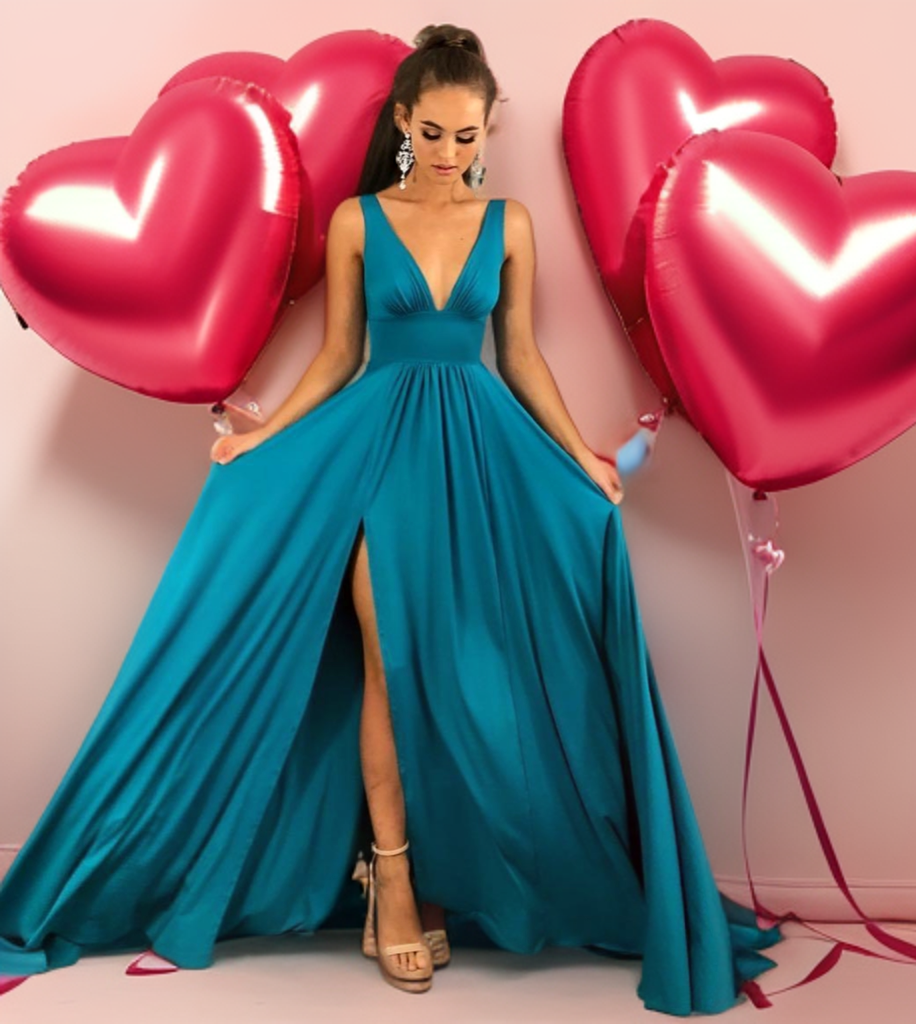 a woman in a long blue dress holding red heart balloons