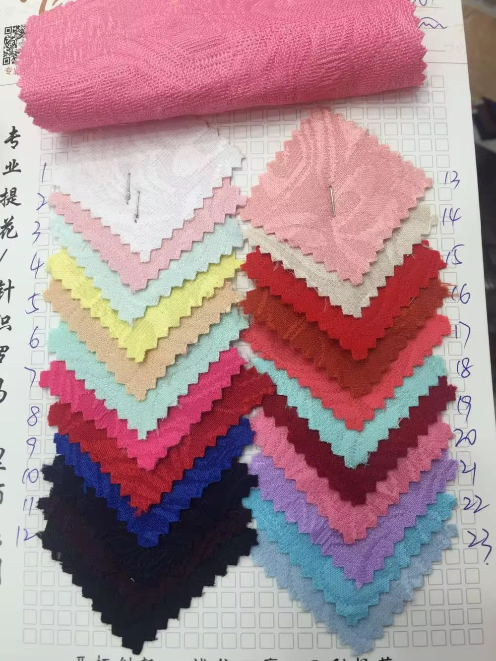 Colorful fabric swatches including pink, red, blue, and other shades, arranged for textile selection.