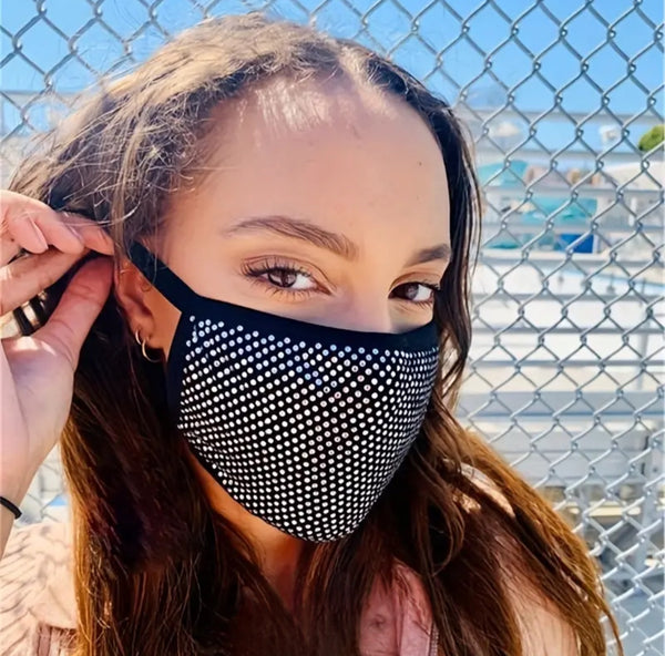 a woman wearing a black and white face mask