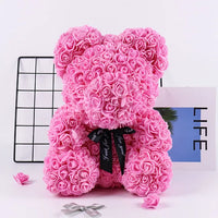 a pink teddy bear made out of flowers