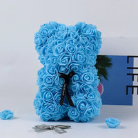 a blue teddy bear made out of flowers