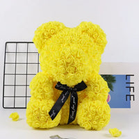 a yellow teddy bear made out of roses