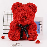 a red teddy bear made out of roses