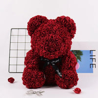 a red teddy bear made out of roses