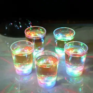 a group of glasses filled with liquid on top of a table