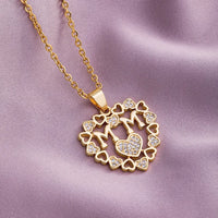 a gold necklace with hearts and a lock on it