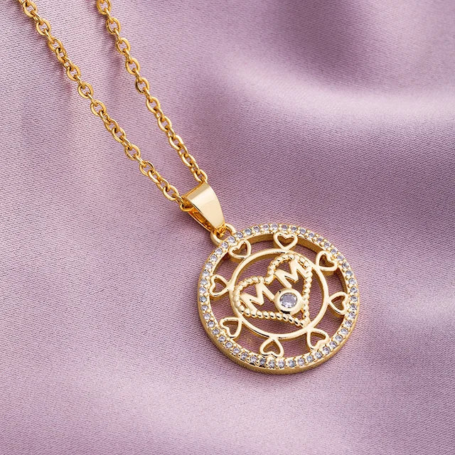 a gold necklace with a diamond on it