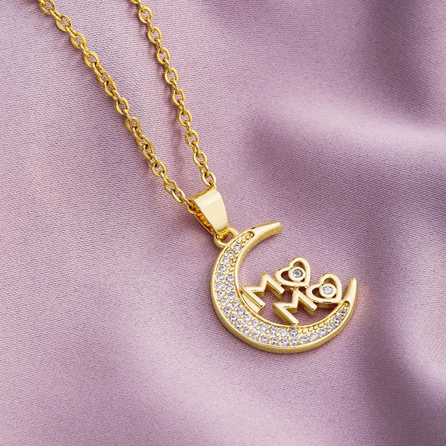 a gold plated necklace with an omen symbol on it