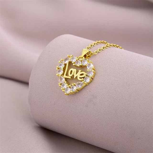 a gold necklace with the word love on it