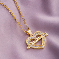 a gold necklace with a heart and a name on it