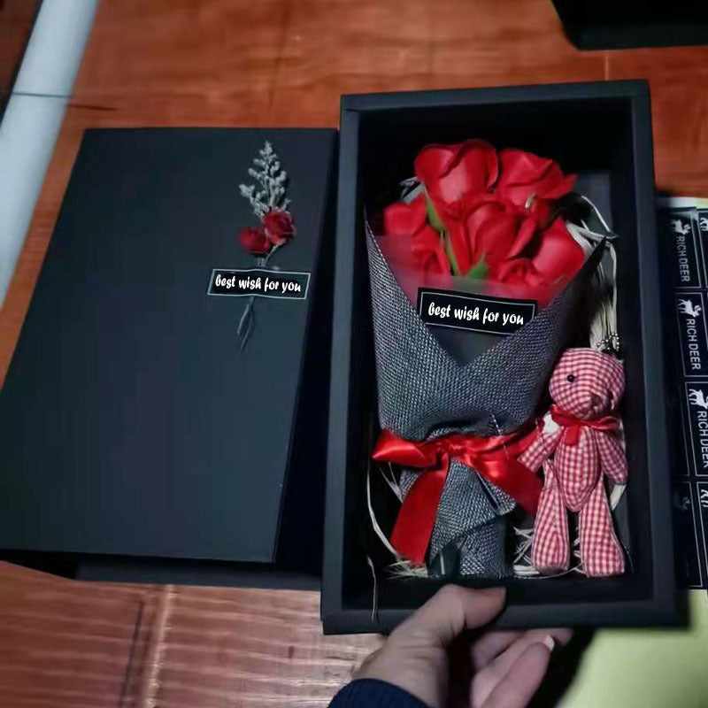 a person holding a bouquet of roses in a box