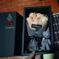 a person holding a bouquet of flowers in a box