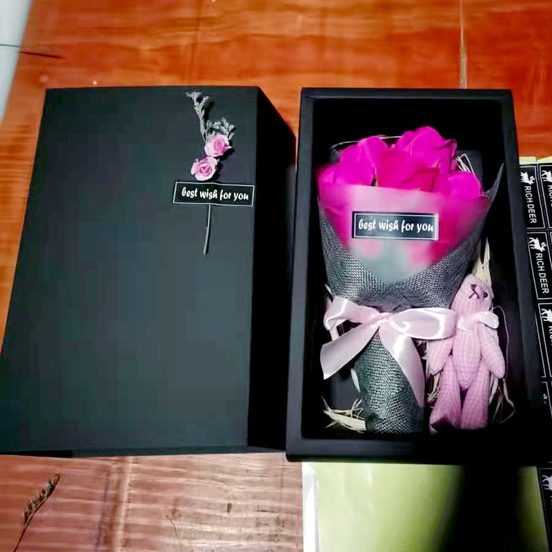 a black box with a pink rose in it