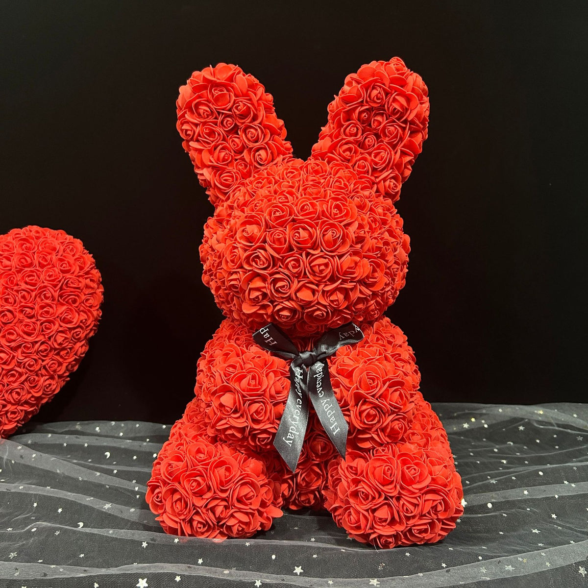 a red teddy bear made out of roses