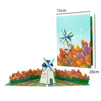 a pop up card with a windmill in a field of flowers