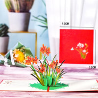 a card with flowers on it sitting on a table